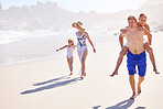 Holiday, kids and parents on beach with bonding, fun and outdoor travel adventure together. Mom, dad and children walking on summer vacation with ocean, water and happy family play on tropical island