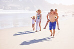 Holiday, kids and parents walking on beach with bonding, fun and outdoor travel adventure together. Mom, dad and children play on summer vacation with ocean, water and happy family on tropical island