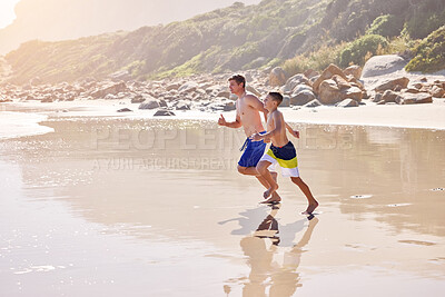 Buy stock photo Father, son and running at beach for vacation, bonding or love in summer, outdoor and together in nature. Dad, child and playful with care, holiday or people with family in sunshine by ocean in Spain