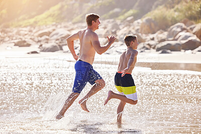 Buy stock photo Water, kid and dad running on beach with fun, travel and bonding together on tropical holiday adventure. Waves, father and son playing on island vacation with ocean, outdoor race and happy summer