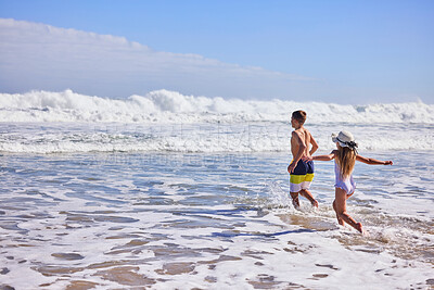 Buy stock photo Playing, happy and children at beach in waves for summer vacation, holiday and weekend on tropical island. Relax, family and kids in water, ocean and sea for bonding, relationship and fun together