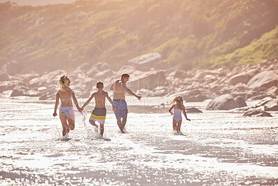 Buy stock photo Waves, kids and parents running on beach for fun, travel holiday or bonding together on tropical adventure. Water, energy and family playing on island vacation with ocean, splash and summer from back