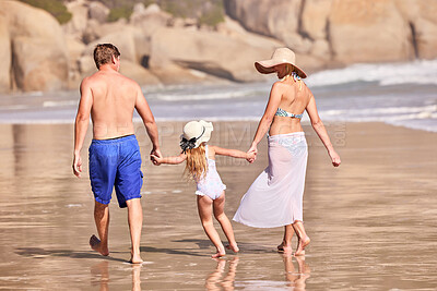 Buy stock photo Walk, kid and parents holding hands on beach for fun, travel holiday and bonding together on tropical adventure. Mom, dad and girl on family vacation with ocean, support and island summer from back
