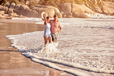 Buy stock photo Happy, beach and couple at sunset walking for bonding, relax together and relationship by ocean. Dating, travel and man and woman with affection for romance on holiday, vacation and weekend in waves