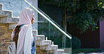 University, campus and Islamic woman with backpack, walking and study opportunity in education. Muslim, culture and happy college student in hijab on outdoor morning commute for learning at school