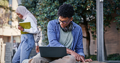 Buy stock photo Reading book, outdoor or college student on laptop for IT course, studying or research on internet. Education, campus or man with headphones, notes or technology for knowledge, university or website
