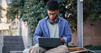 Buy stock photo Man, student and glasses with laptop outdoor for university project, research and information of education. Smile, male person and typing with digital for online learning, exam results and studying