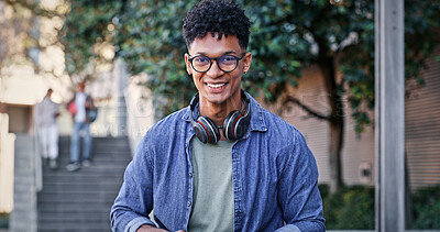 Buy stock photo Student, happy and portrait on campus for education, glasses and pride for academic achievement. Man, smile and headphones at university for knowledge, development and college scholarship in Brazil