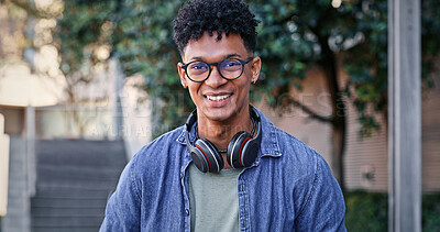 Buy stock photo Student, smile and portrait on campus for education, glasses and pride for academic learning. Man, happy and headphones at university for knowledge, development and college scholarship in Brazil