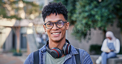 Buy stock photo Student, happy and portrait at college for education, glasses and pride for academic achievement. Man, smile and headphones on campus for knowledge, development and university scholarship opportunity