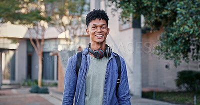 Buy stock photo Man, happy and portrait at university for education, opportunity and pride for academic acceptance. Student, smile and headphones on campus for knowledge, development or college scholarship in Brazil