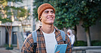 University, student and man with thinking outdoor on campus with book for education, learning or scholarship. Gen z, person or happy at college for studying, knowledge or backpack for research ideas