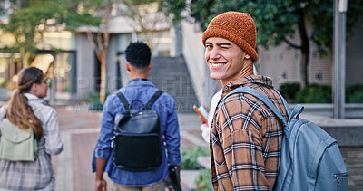 Buy stock photo University, student and man wink in portrait on campus with backpack for education, learning and scholarship. Gen z, person or happy at college for studying, knowledge or walking for research outdoor