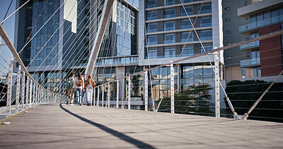 Buy stock photo City, people and students walking on bridge together with buildings, backpack and travel to college campus. University, scholarship and group of friends on morning commute to urban academy from back