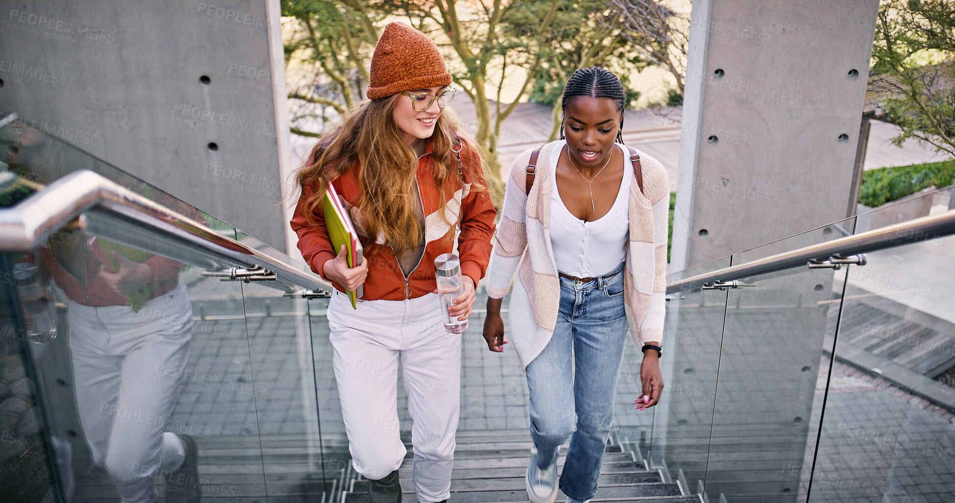 Buy stock photo Conversation, education and walking with friends on steps at college or university campus for learning. Development, growth and study with student women outdoor on school stairs together for future