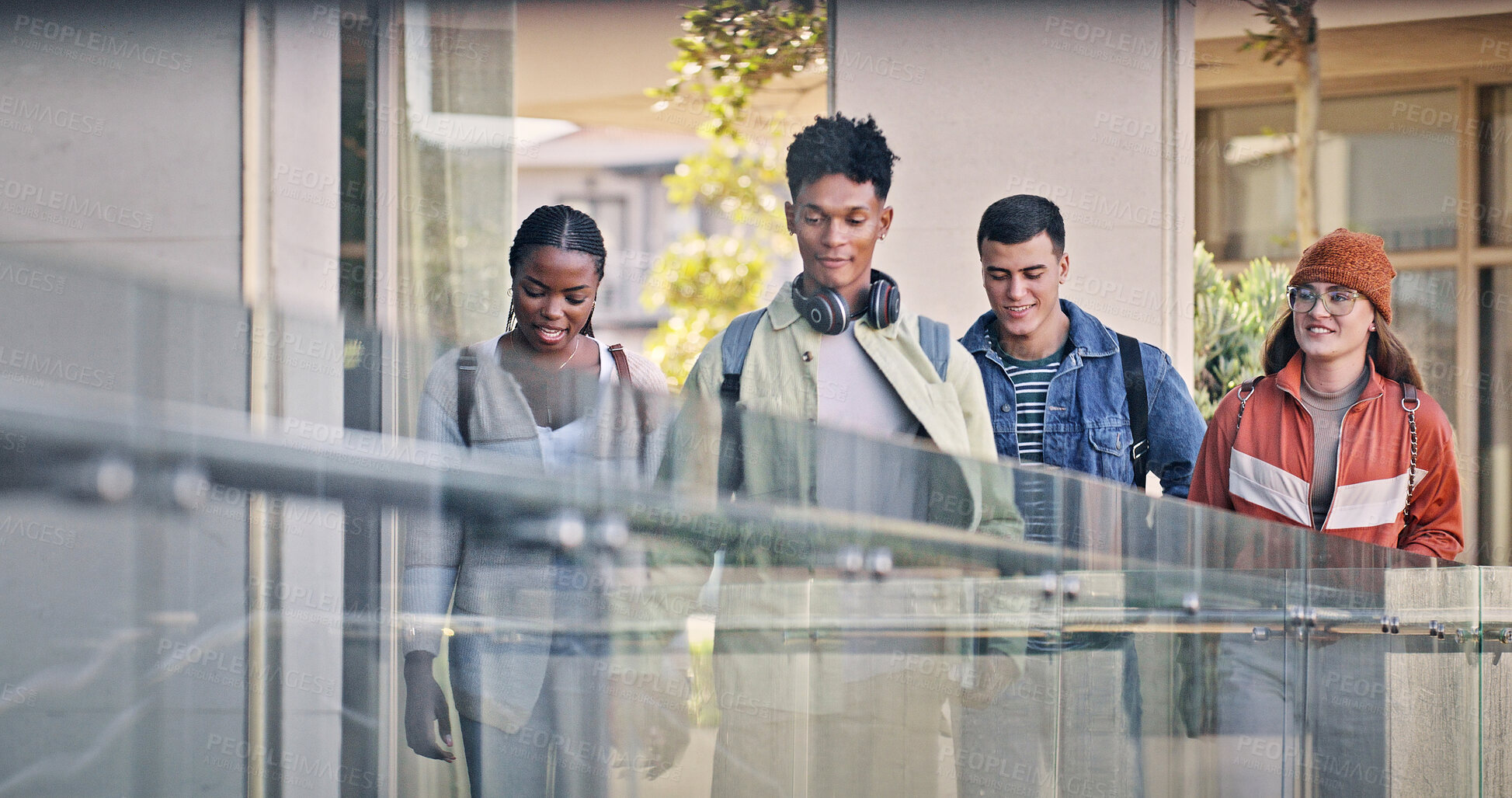 Buy stock photo Students, walking and chat at university for education, new semester and ready for learning. People, friends and talking on campus for catch up, gossip and social with diversity in community college