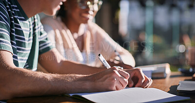 Buy stock photo Outdoor, hands and university student with writing on notebook for research, assignment and essay. People, campus and smile on group work at college with studying for exam or assessment as classmates