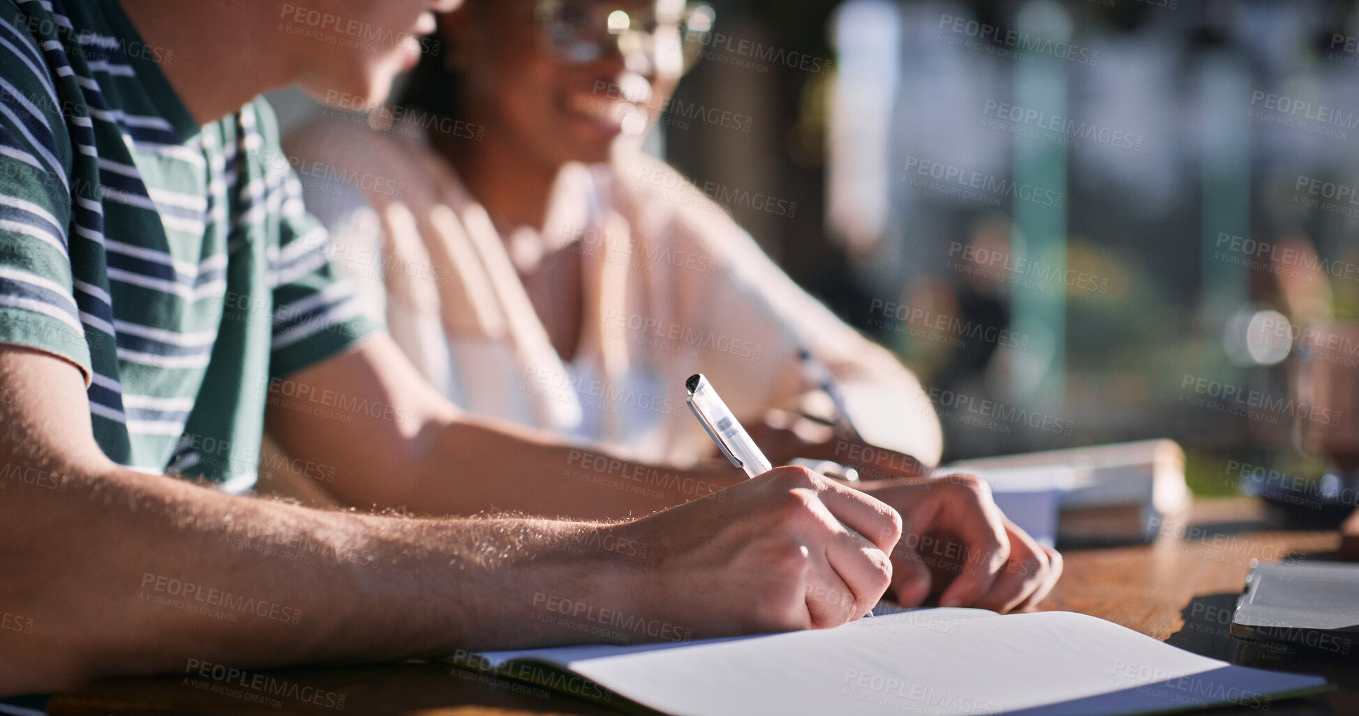 Buy stock photo Outdoor, hands and university student with writing on notebook for research, assignment and essay. People, campus and smile on group work at college with studying for exam or assessment as classmates