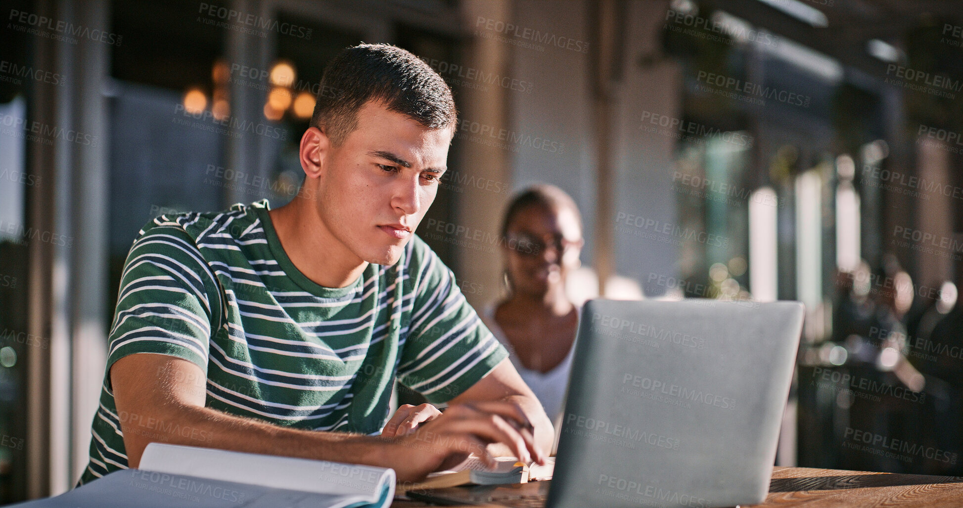 Buy stock photo Man, university student and campus with reading on laptop for assignment and essay writing. Male person, college learner and textbook for education with research or study for exam and assessment