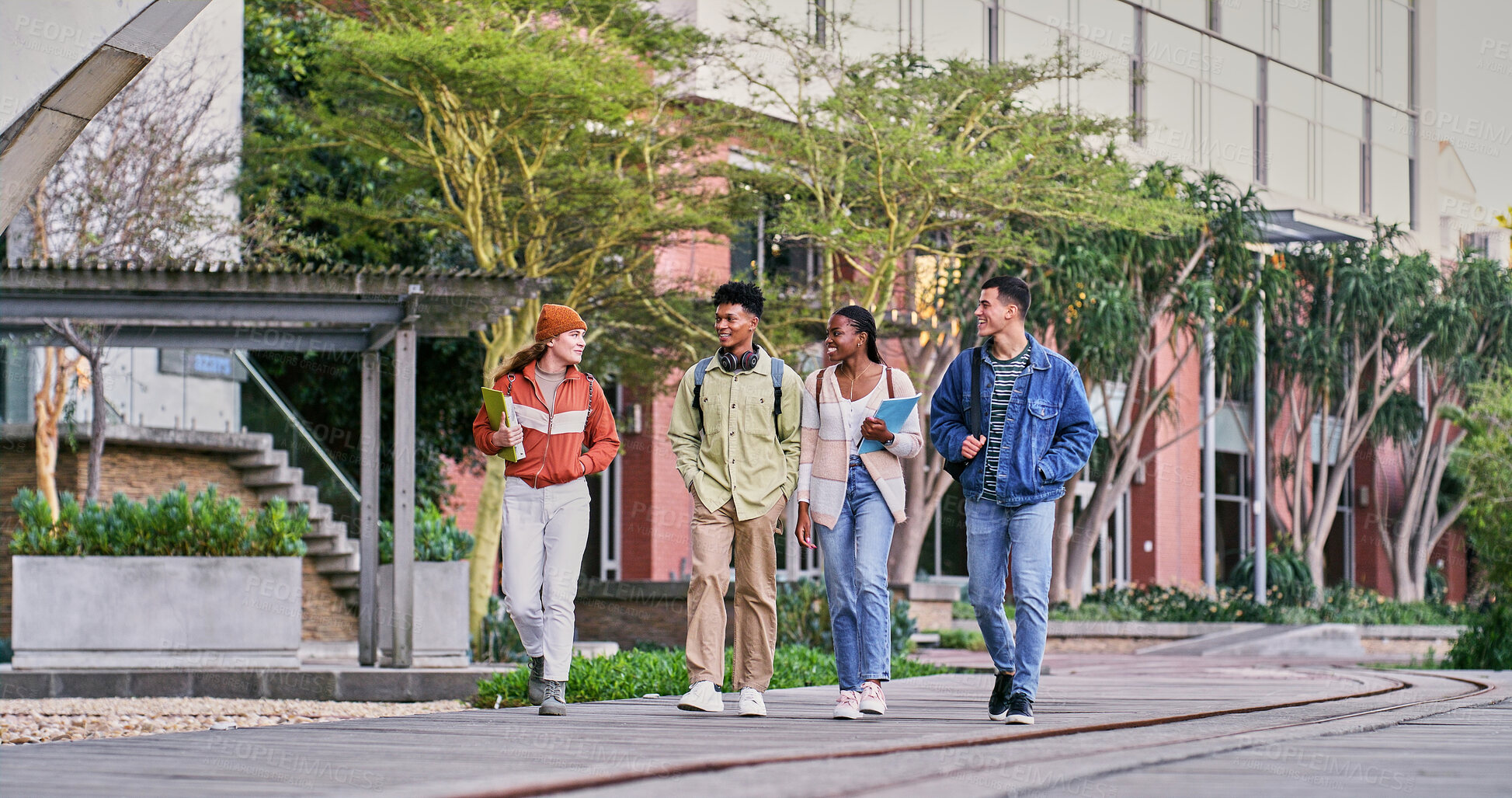 Buy stock photo Group, students and walking with people, smile and backpacks for outdoor on campus or university. Friends, happy and talking for education, development and scholarship for learning, college or school