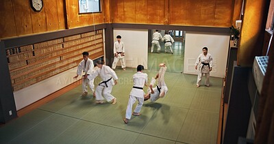Buy stock photo Martial arts, fight demonstration and people with learning, exercise and karate in dojo. Japan, training and fitness studio with sport, discipline and warrior in taekwondo class in gym above