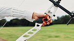 Hands, archer and bow for training, ready and preparing for competition, equipment and outdoor for game. Contest, athlete and practice from tournament, skills and challenge for person in Japan