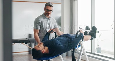 Buy stock photo Physiotherapist, person and recovery on fitness bench for exercise, help or progress at clinic. People, biokinetics and support with guide for rehabilitation process with inversion table at hospital