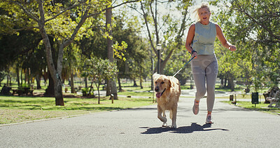 Buy stock photo Outdoor, woman and happy for running with dog for fitness, exercise and workout in England. Mature person, park and smile with jog as pet owner or animal on with adoption, support and self care