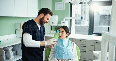 Buy stock photo Dentist, mouth model and man with woman in clinic for teeth cleaning, dental hygiene and demonstration. Healthcare, dentistry and patient with hygienist for consulting, oral care and medical service