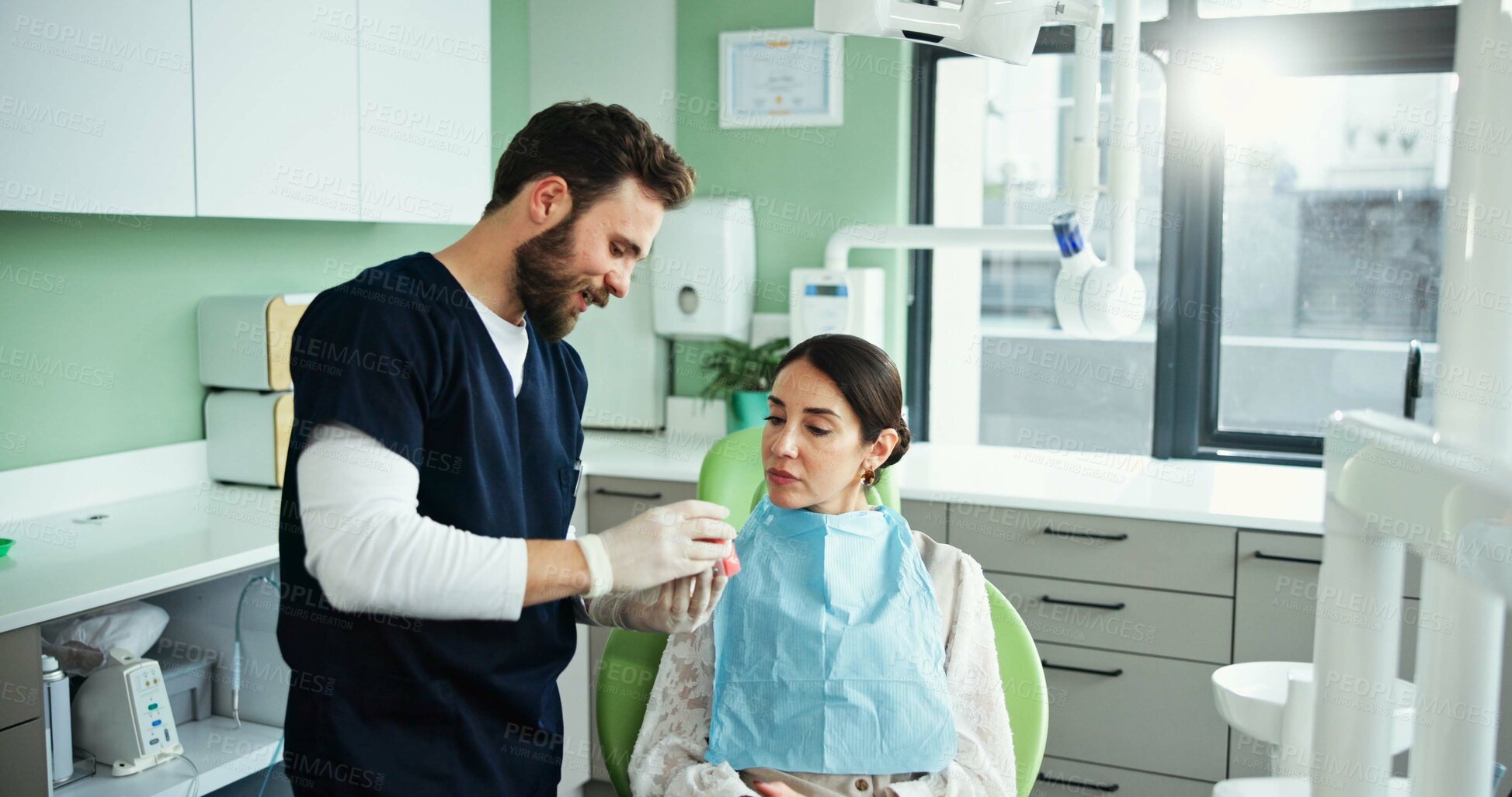 Buy stock photo Dentist, mouth model and man with woman in clinic for teeth cleaning, dental hygiene and demonstration. Healthcare, dentistry and patient with hygienist for consulting, oral care and medical service