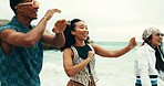 Happy, people and dancing on beach outdoor with energy, movement and vacation reunion for rave festival. Group, friends and rhythm at island party, summer freedom and bonding together of travel trip 