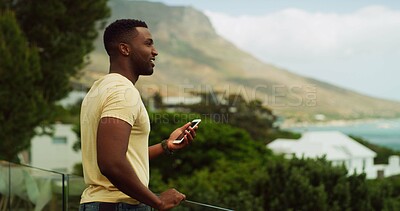 Buy stock photo Phone, thinking and vacation with black man outdoor in nature for scenic holiday or travel to coast. Adventure, explore and view with happy influencer person in mountain location for tourism review