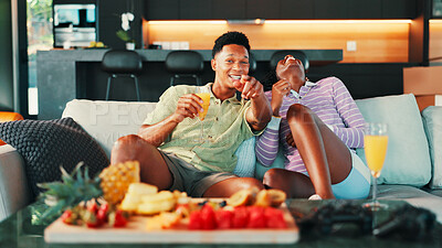 Buy stock photo Watching TV, snacks and people on sofa in home for movie, comedy or show together for date. Platter, mimosas and couple for relaxing, bonding and streaming film in living room in house for love.