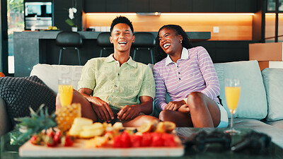 Buy stock photo Laugh, snacks and couple on sofa in home watching tv for movie, film or show together for date. Platter, mimosas and man with woman for relaxing, bonding and streaming series in living room in house.
