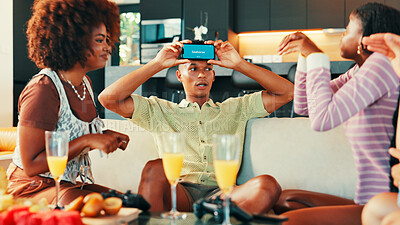 Buy stock photo Action, game and phone with friends in living room of home together for bonding or social gathering. App, explain and guess with people acting in apartment for challenge, competition or reunion