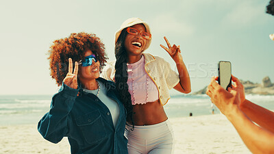 Buy stock photo Happy, peace sign and friends on beach for picture on holiday, summer vacation and adventure in nature. Relax, emoji and girls hug for photo for social media, online post and memory on weekend at sea