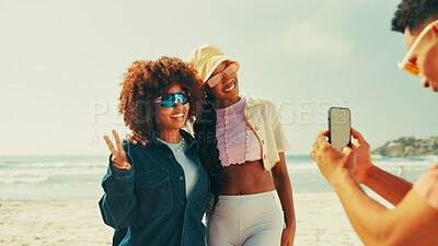 Buy stock photo Beach, friends and smartphone for picture, travel and holiday with tropical island, break and nature. Ocean, people and smile with cellphone, capture memory and excited with vacation and Zanzibar