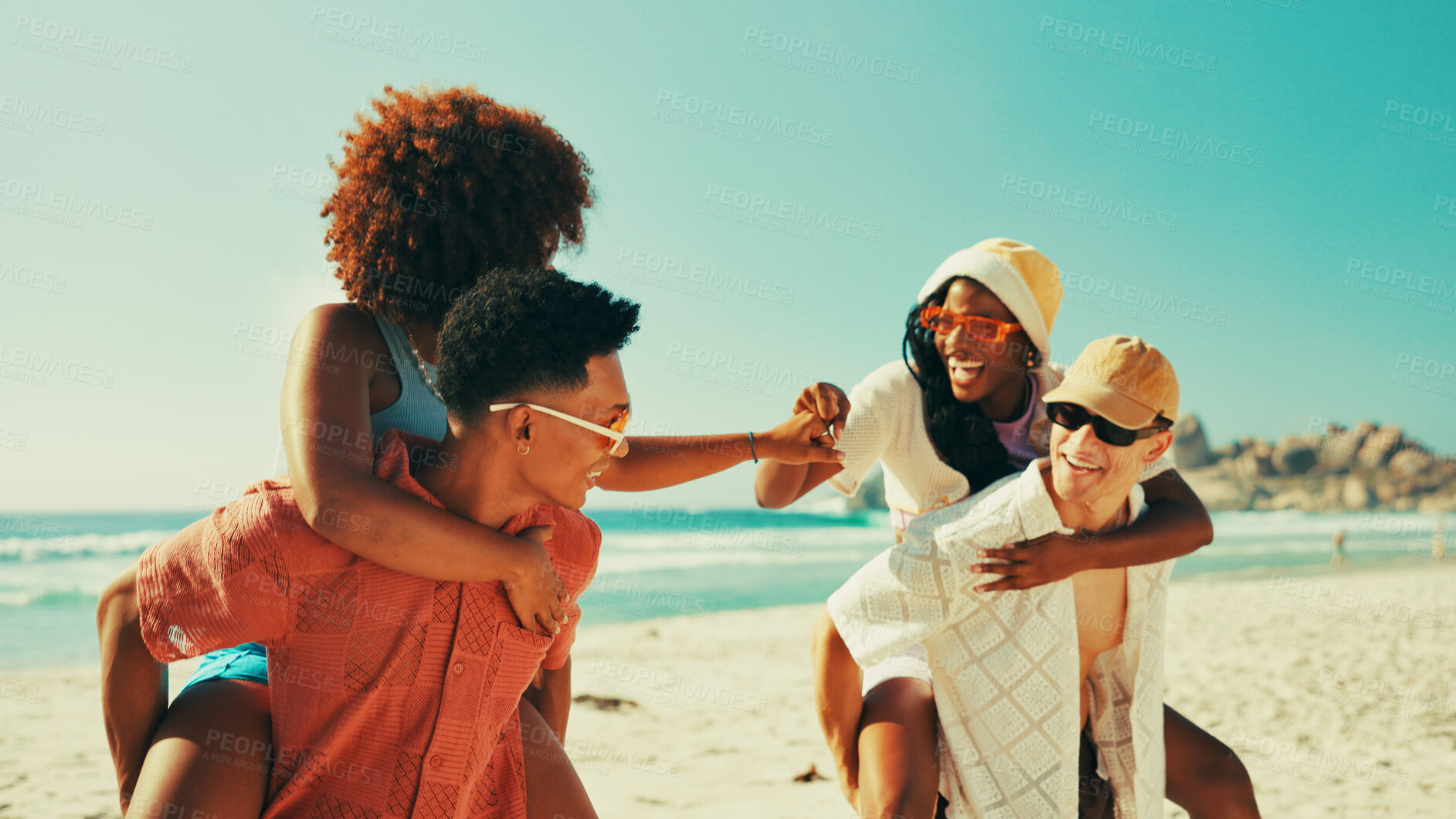 Buy stock photo Couple of friends, fist bump and piggyback on beach with people outdoor for holiday or vacation. Bonding, laughing or love with group of men and women on coast together for travel or weekend