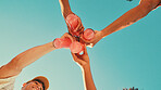 Hands, drinks and toast with friends, low angle and blue sky with celebration, cheers or event in summer. People, bottle and soda with party, solidarity and vacation with success, achievement or goal
