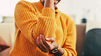 Elbow, injury and pain for person, home and joint with inflammation in living room, cramp and hurt. Hands, accident and woman with muscle tension in house, healthcare and symptoms of arthritis