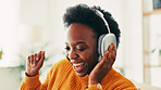 Black woman, music and headphones in home for dance to audio, radio and hearing podcast on sofa. Happy african person relax for streaming sound, multimedia and online subscription in living room