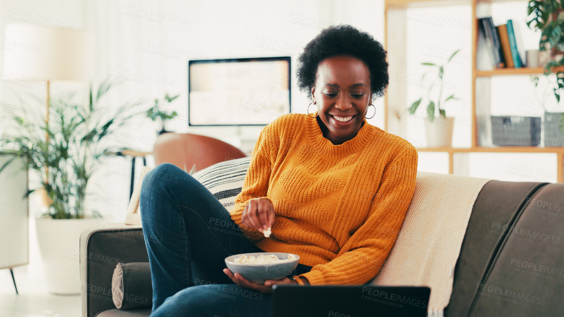 Buy stock photo Black woman, laptop and movie on sofa with popcorn, happy and laughing with comedy in home. Person, relax and computer with snack, film or subscription for streaming on couch in living room at house