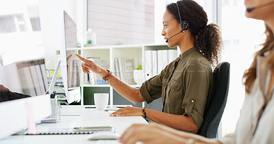 Buy stock photo Woman, consultants and pointing with headset at call center for telemarketing or customer service. Female person, agent or employees talking with mic for online assistance, help or desktop support