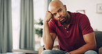 Annoyed, body language and portrait with man on sofa in living room of home for fail or mistake. Frustration, moody and stress with unhappy or sad person in apartment for attitude and depression