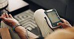 Home, blood pressure and hands of man with machine for test, hypertension and check pulse on sofa. Healthcare, above and person with medical equipment for exam, monitor and measure heart rate