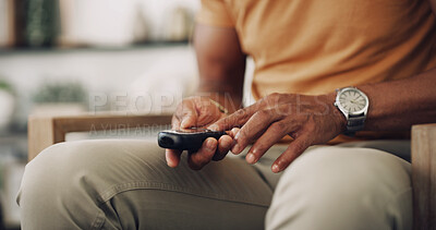 Buy stock photo Home, hands and man with diabetes, testing for glucose levels and chronic disease. Closeup, healthcare and person in living room with medical meter, sugar and insulin machine to monitor hypertension