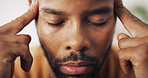Man, face and headache in home with tension, stress and pressure for health crisis. African person, closeup and migraine in living room with vertigo, dizzy spell and massage temple for pain relief