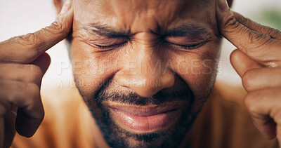 Buy stock photo Man, face and headache in home with stress, tension and pressure for health crisis. African person, closeup and migraine in living room with vertigo, dizzy spell and massage temple for pain relief