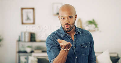 Buy stock photo Person, portrait and blow kiss in home for love, flirty and date for valentines day. African man, gesture and expression in living room for romance, care and show appreciation in relationship