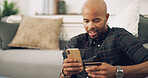 Home, black man and mobile with credit card for online shopping, password information and payment. Lounge, male person and phone with debit for ecommerce, transaction and subscription for application